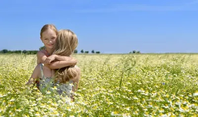 Mother and daughter in field of flowers