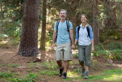 couple walking hand in hand and hiking