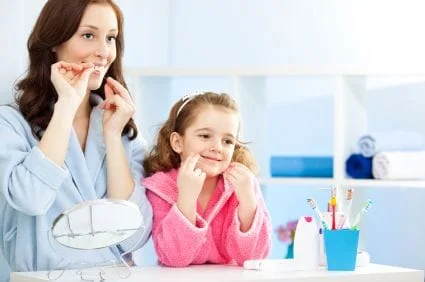 mom and daughter flossing