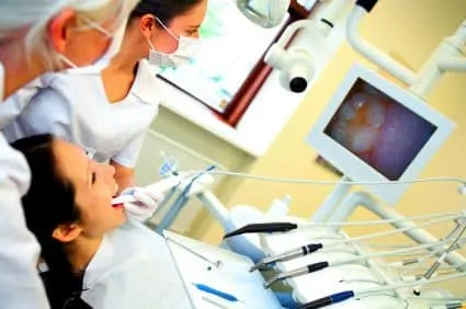 dental assistant performing digital x-ray of tooth in female patient's mouth, Columbia, MO dentist
