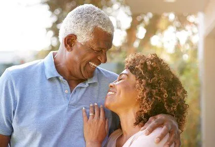 older black man and woman embracing and smiling, dentures Zebulon, NC family dentist