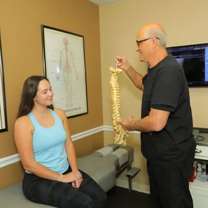 doctor showing a spine to a patient
