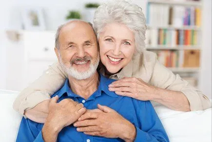 elderly man and woman embracing, smiling nice dentures, Financial District, NY dentist 