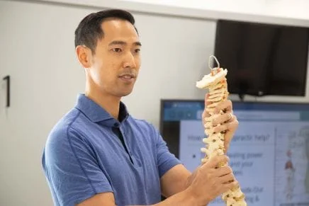 A doctor holding a spine