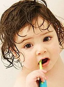 baby with toothbrush