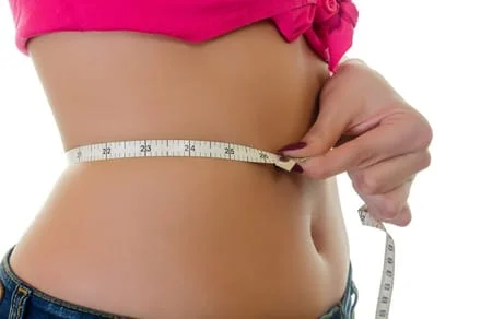 A girl measuring her waist