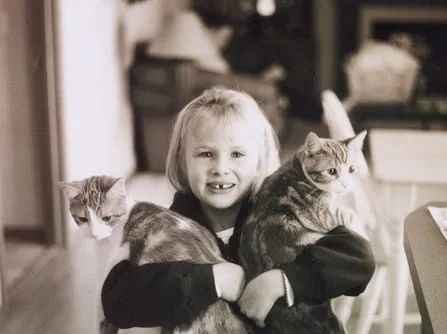 girl hugging animals