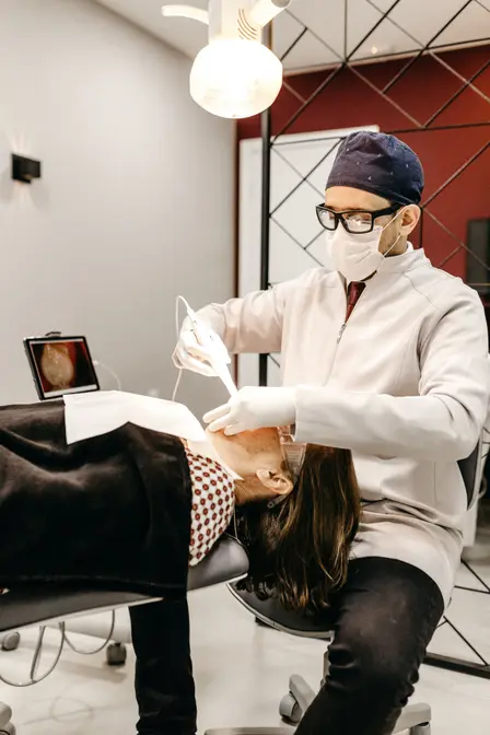 Photograph of dentist performing tooth extractions, Durham, NC