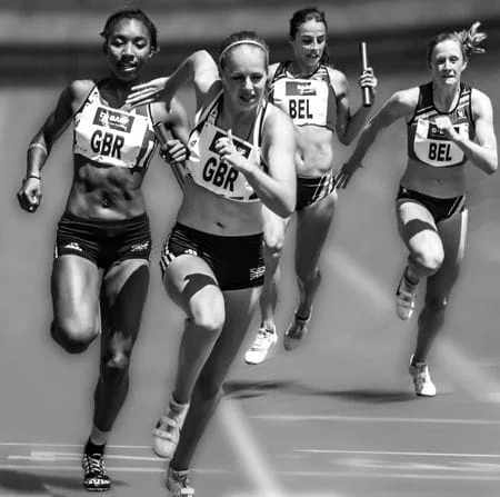 group of four women running on track