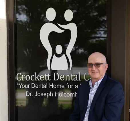 Dr. Holcomb outside of the Crockett Dental Care office entrance.