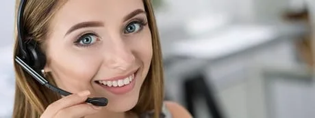 woman smiling while wearing a headset