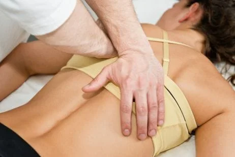 Chiropractor adjusting patients back
