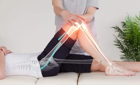 physical therapist adjusting knee
