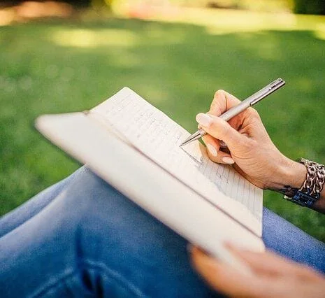 writing in a journal while sitting