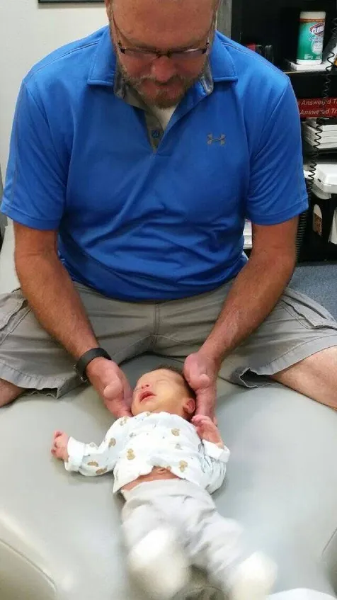 Dr. McDaniel performs a safe and gentle pediatric adjustment on an infant