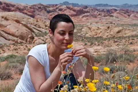 Women after cancer treatment smelling flowers
