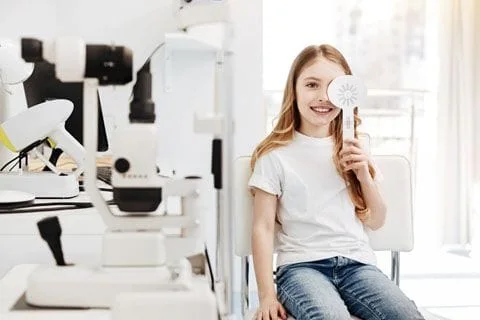 Young girl having eyes examined