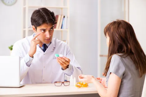 Doctor showing contact lenses