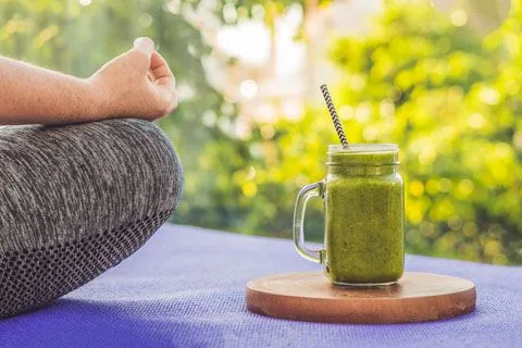 Women in yoga pose with a shake