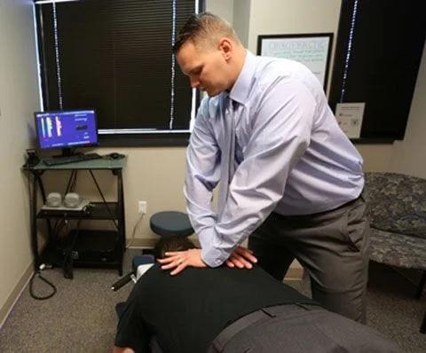 Man getting adjusted by a Chiropractor