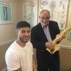 Dr. Brandford Pizza with chiropractic patient.