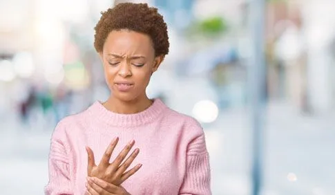 Women holding wrist in pain