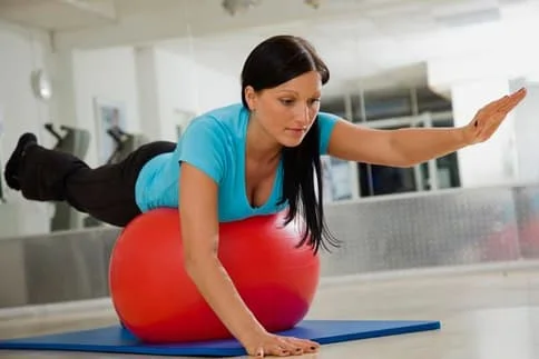 Woman on exercise ball at chiropractic office