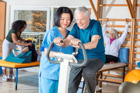 Doctor working with patient on excercise bike