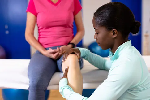 Doctor examining knee