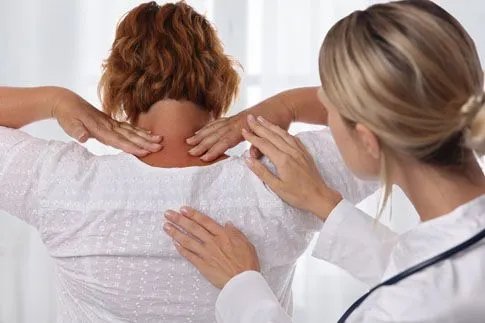doctor touching patient's head and neck