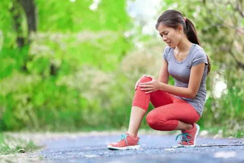 Women holding knee in pain