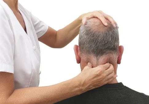 Older male having therapy on neck