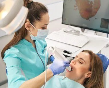 dentist taking digital dental impressions in woman's mouth for CEREC Crowns - Melrose, MA dentist