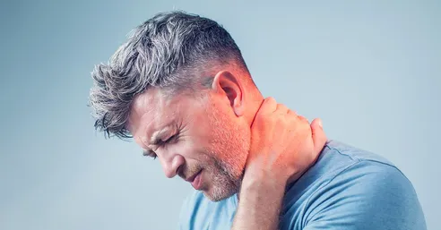 man holding neck in pain