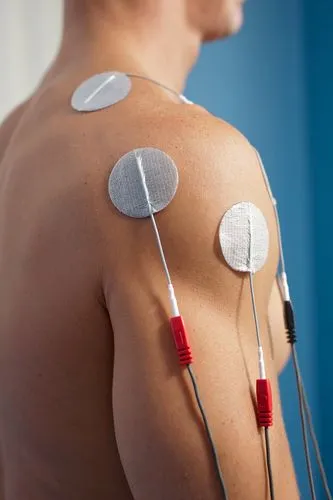 Patient undergoing interferential current therapy at a chiropractic office