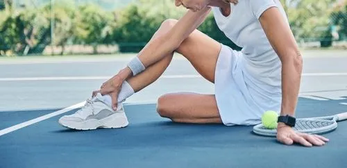 Athlete having an injury on tennis court