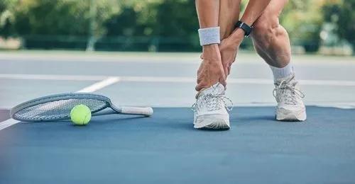 athlete holding his ankle