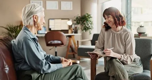 Elderly patient participating in a one-on-one therapy session with a licensed therapist