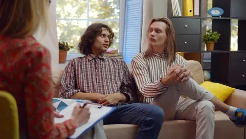 Gay couple attending a counseling session with a therapist