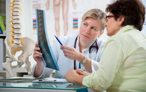 doctor showing spine model to a patient