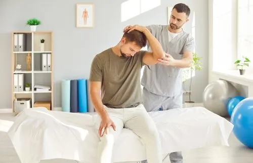 A chiropractor treating a male client as part of worker's compensation care for an injury.