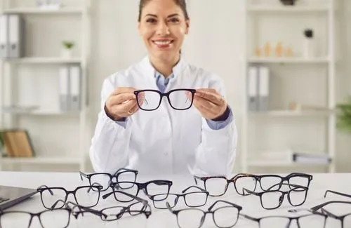 woman holding eyeglasses