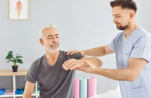 Senior client receiving chiropractic adjustment from chiropractor