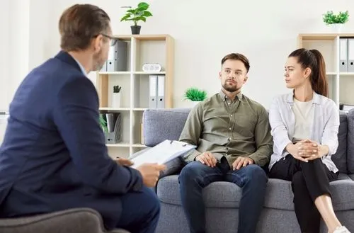 Couple speaking with a therapist during a counseling session