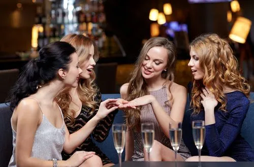 Woman showing to her friends an engagement ring