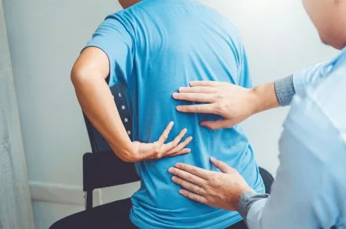 man receiving back pain treatment