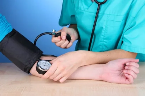 female_doctor_taking_blood_pressure.jpg