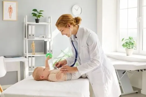 A pediatrician examining and providing care for a newborn baby.