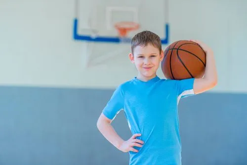 Child holding basketball symbolizing sports physical exam