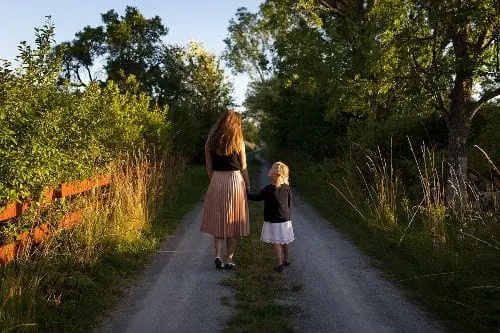 Woman and child walking down a path
